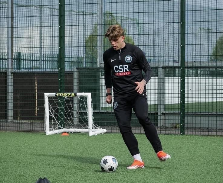 Frankie demonstrating close control during a football coaching session